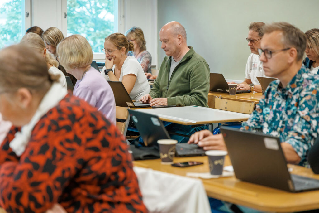 Adults attending a computer class.