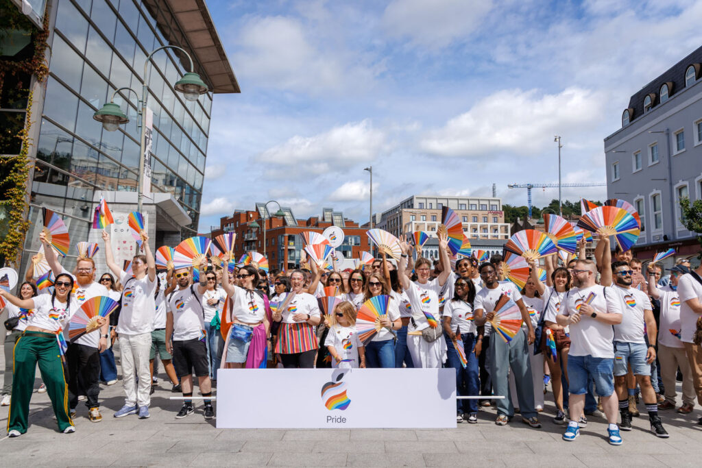 Apple employees celebrate Pride with rainbow fans.