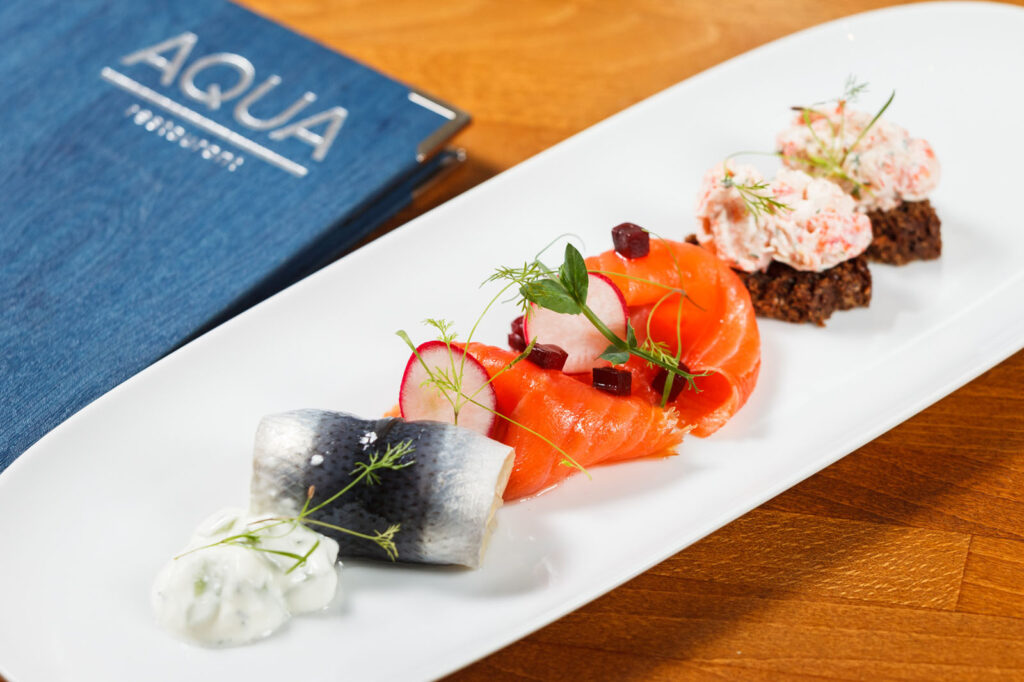 Aqua restaurant's seafood platter: salmon, herring, crab, and garnishes.