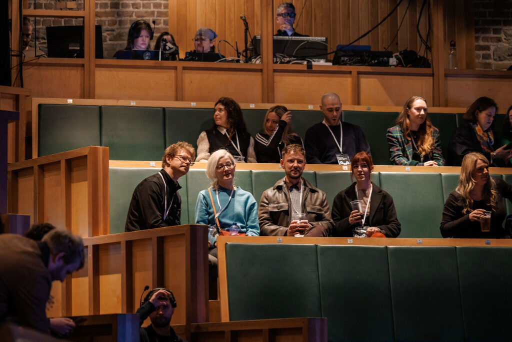 Attendees and crew at a multi-level event venue.