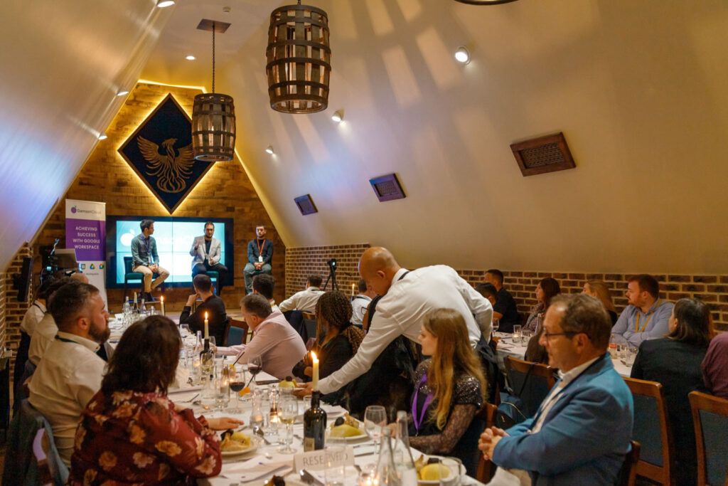Business conference dinner with speakers and attendees.
