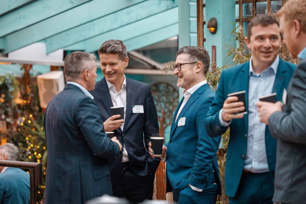 Businessmen networking and chatting at an event.
