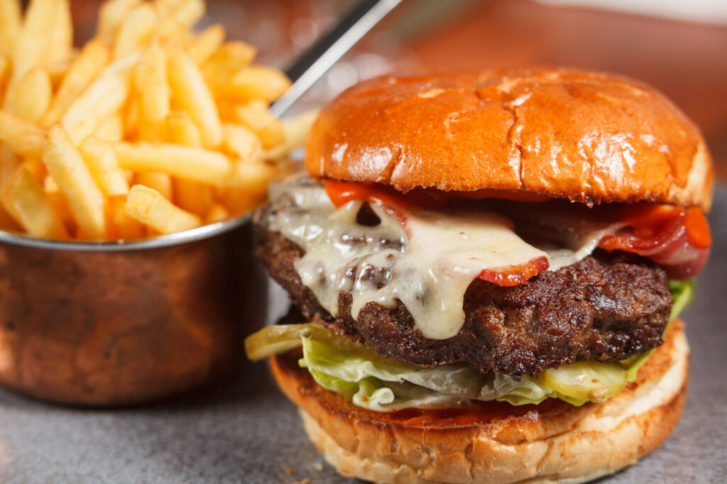Cheeseburger with bacon, cheese, and fries.
