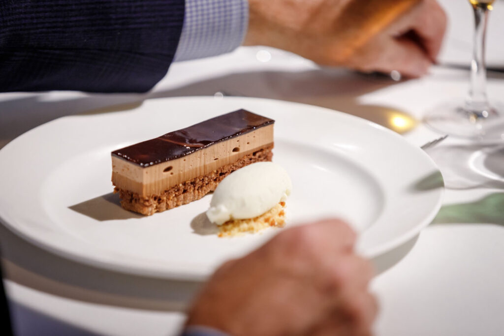 Chocolate cake and ice cream dessert on a white plate.