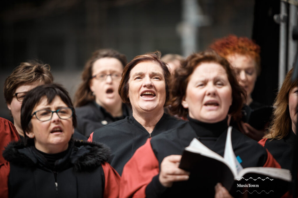 Choir of women singing passionately