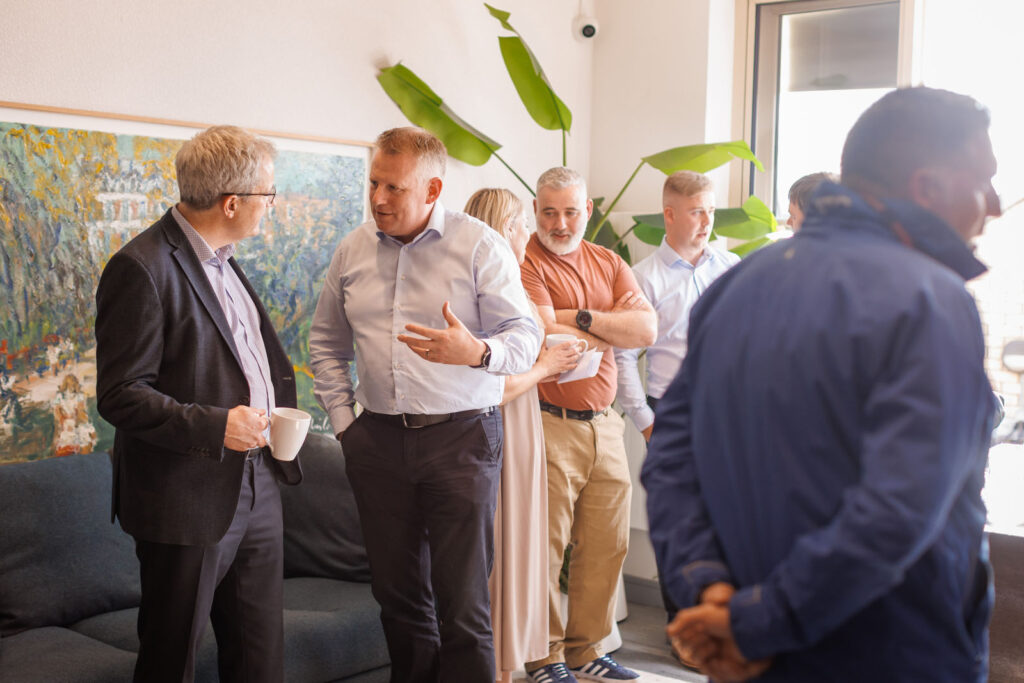 Colleagues chatting and networking during a coffee break.