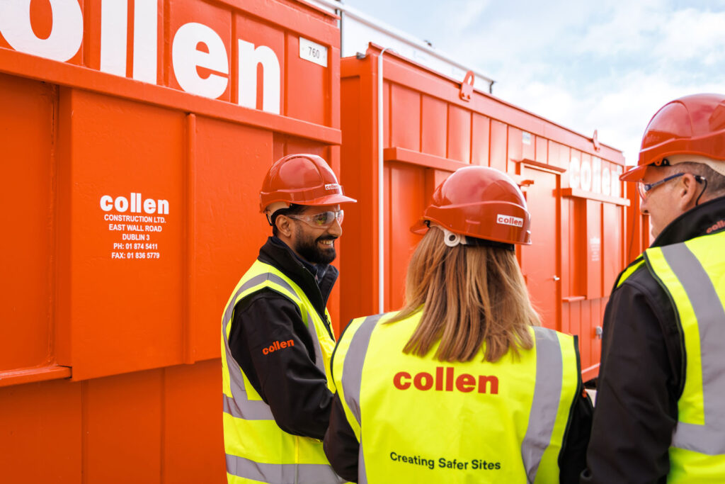 Collen construction workers discussing on site.