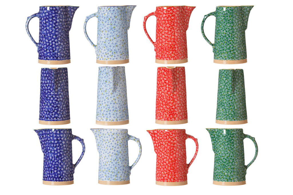 Colorful floral pitchers and tumblers displayed on white background.