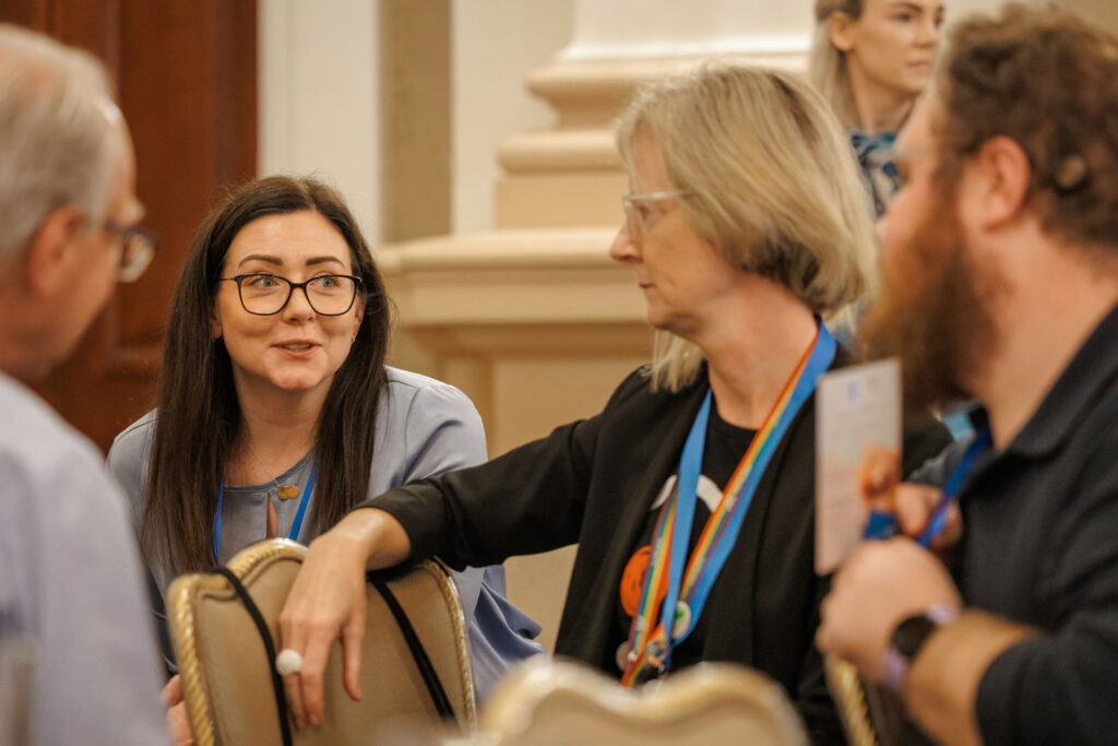 Conference attendees engaged in conversation.