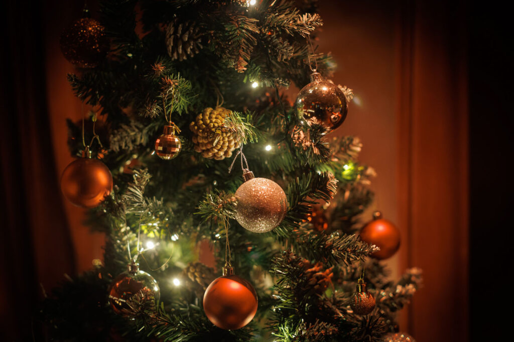 Decorated Christmas tree with sparkling ornaments and warm lights.