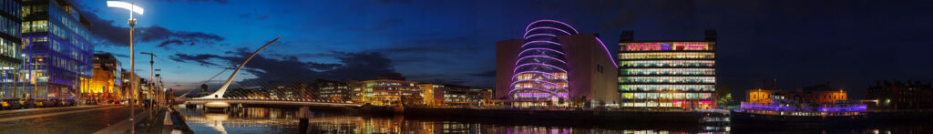 Dublin's modern cityscape at night, featuring Samuel Beckett Bridge.