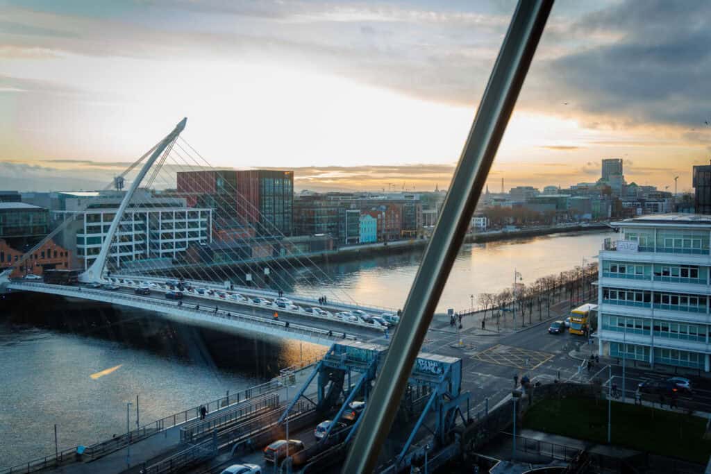 Dublin's Samuel Beckett Bridge and city at golden hour.