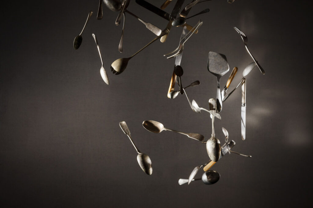 Dynamic display of floating kitchen utensils.