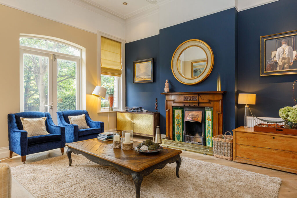Elegant living room with blue accents and a fireplace.