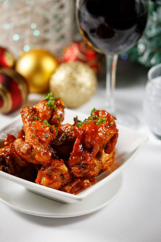Festive chicken wings with red wine and Christmas decorations.