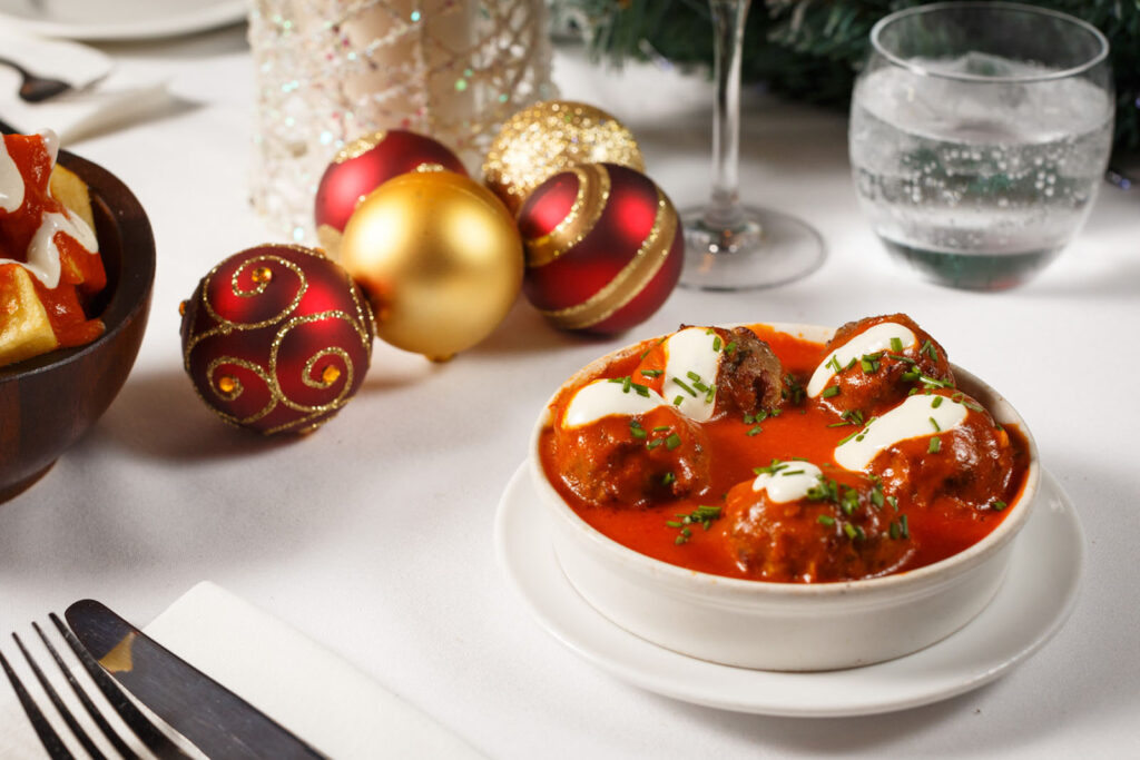 Festive holiday dining with meatballs and Christmas ornaments.