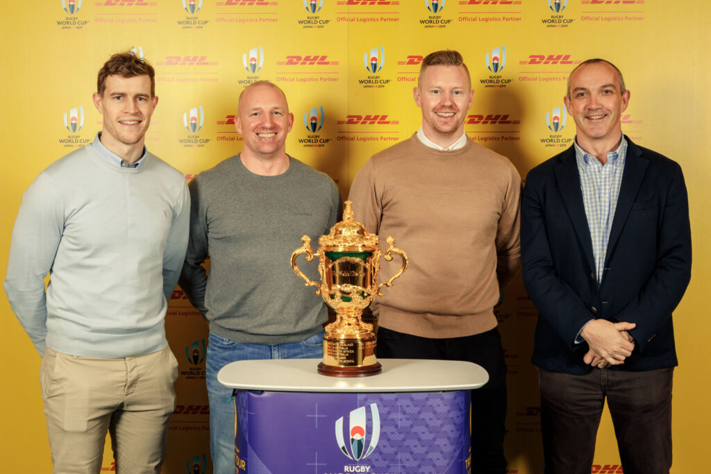 Four men and the Rugby World Cup trophy.