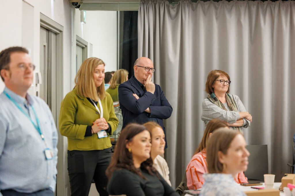 Group of people attending a professional meeting or presentation.