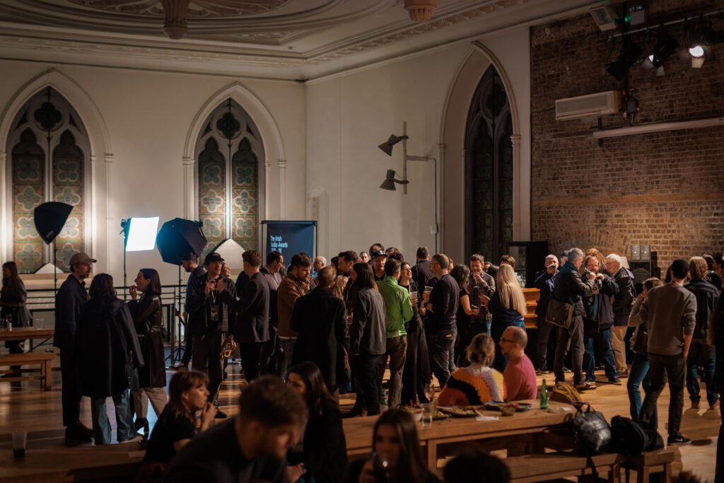 Guests mingle at an indoor awards event.