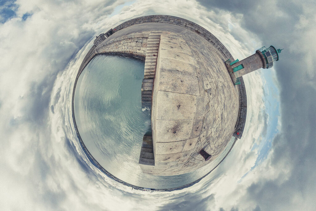 Lighthouse and pier in a circular panoramic view.