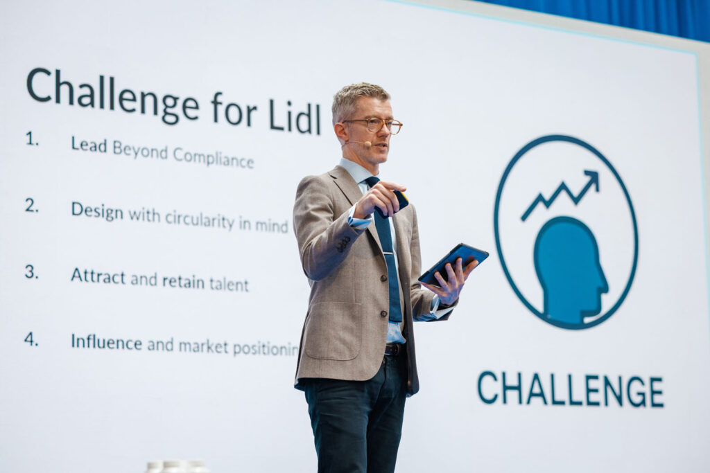 Man presenting business challenges for Lidl on screen.