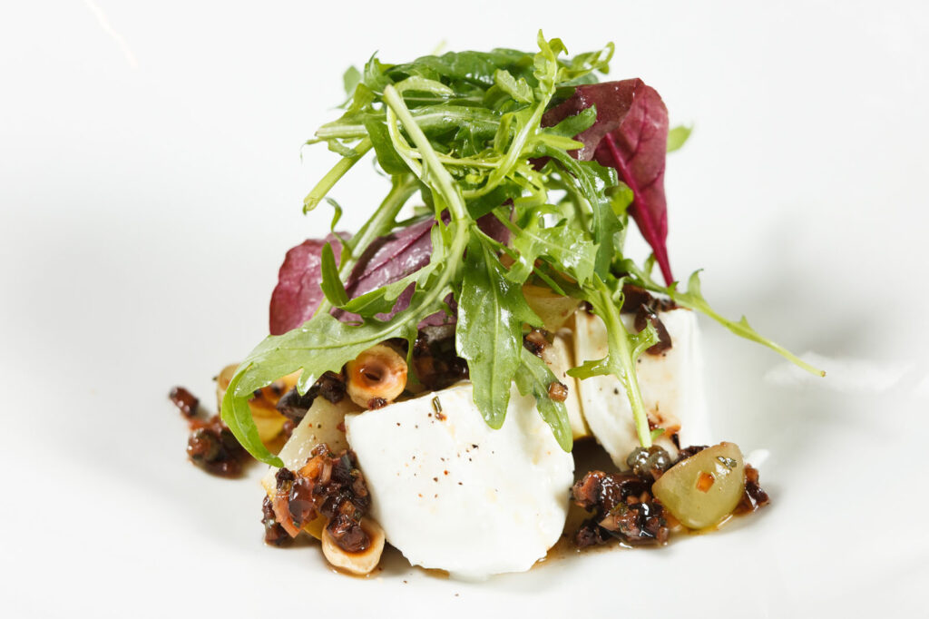 Mozzarella salad with greens, hazelnuts, and olive tapenade.