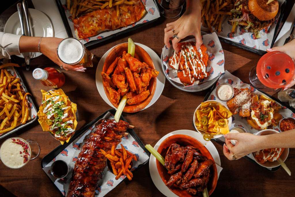 Overhead view of a table laden with American comfort food and drinks.