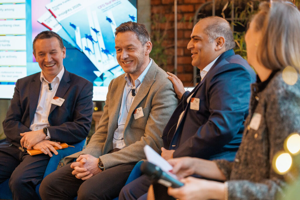Panel discussion with smiling business professionals.