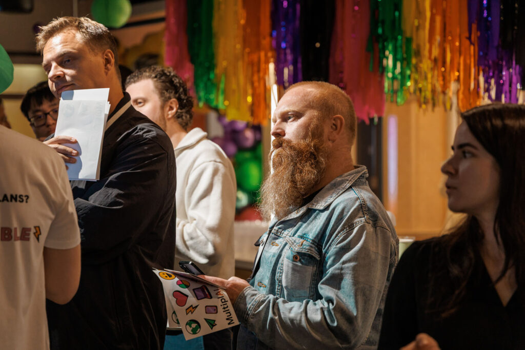 People at an event with colorful decorations and stickers.