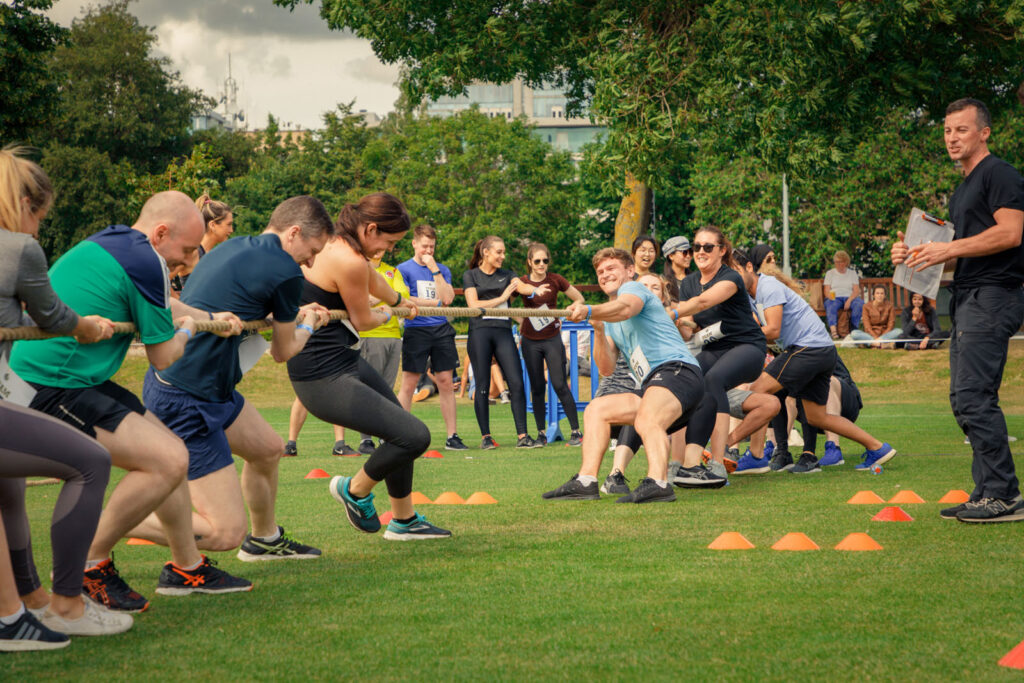 People compete in a lively outdoor tug-of-war game.