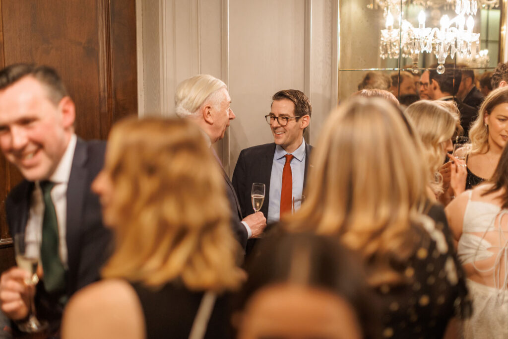People enjoying a formal reception with drinks.