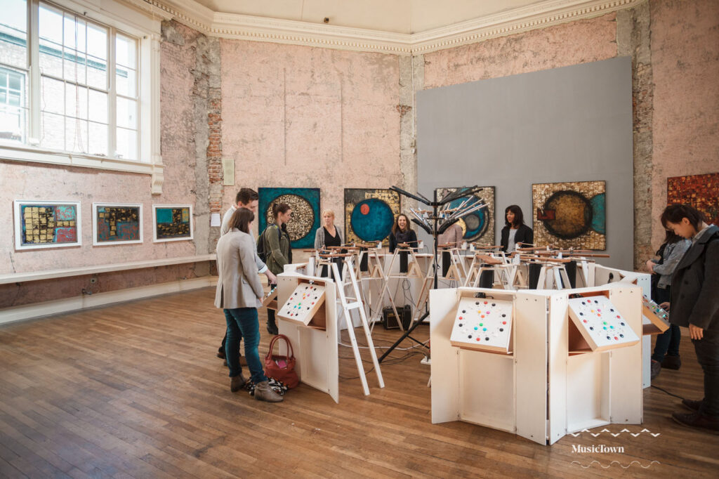People interact with a unique musical art installation.