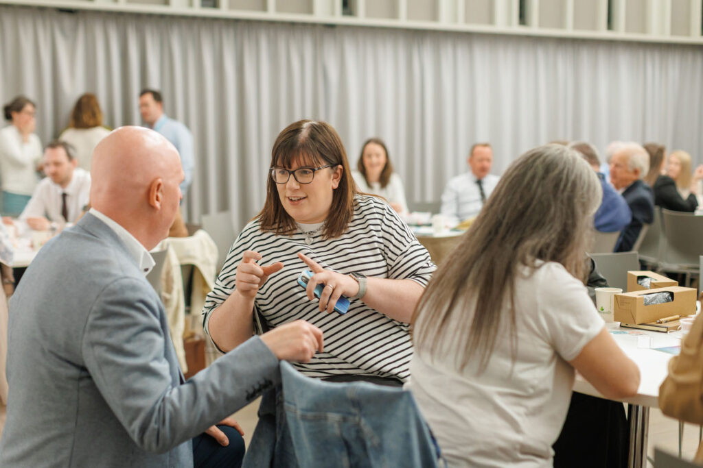 People networking and discussing at a professional gathering.