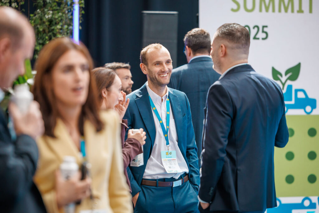 People networking and smiling at a business summit.