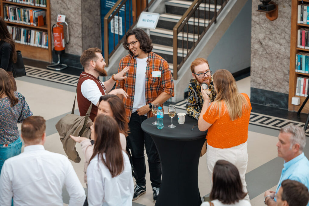 People socializing and networking at an indoor event.