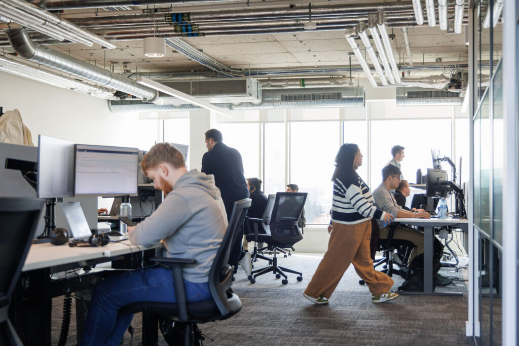 People working in a modern open-plan office.