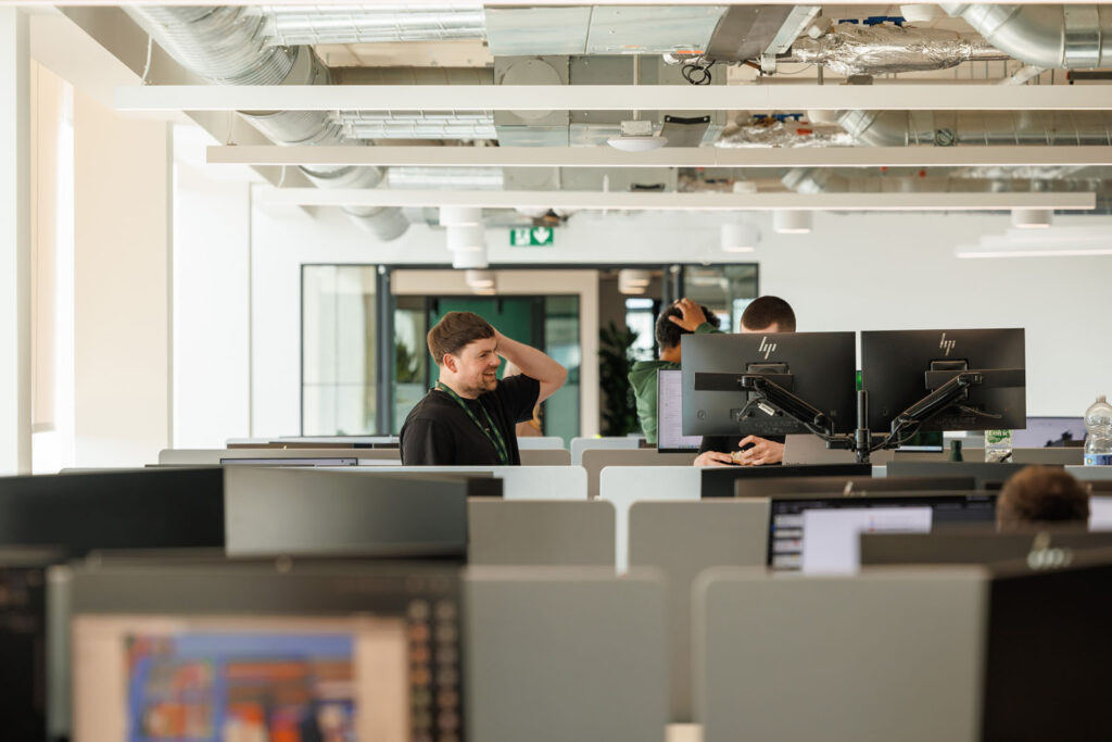People working in a modern open-plan office environment.
