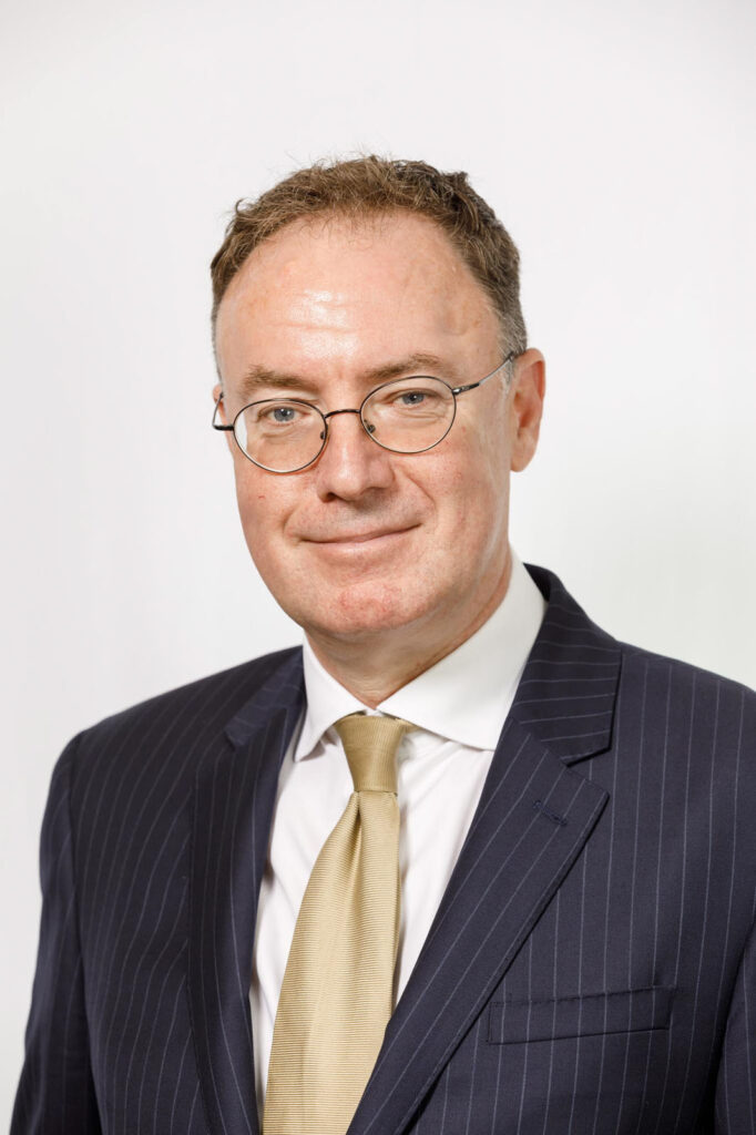 Portrait of a smiling businessman in glasses.