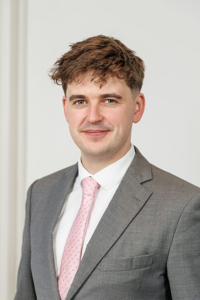 Portrait of a smiling man in business attire.