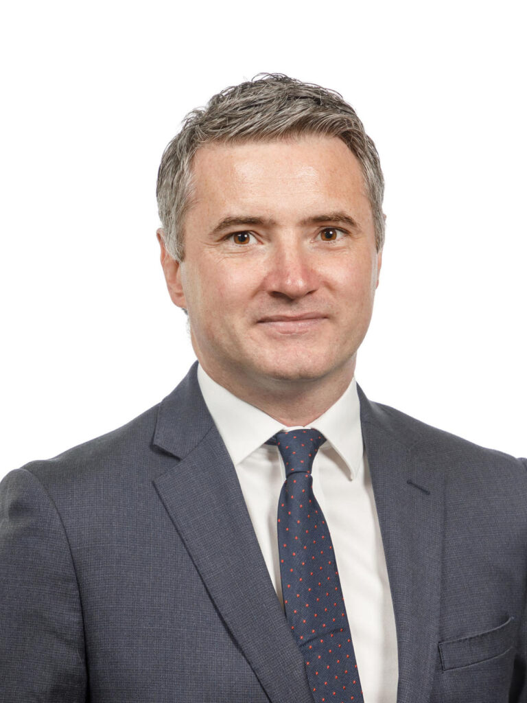 Professional man in suit and tie, headshot.