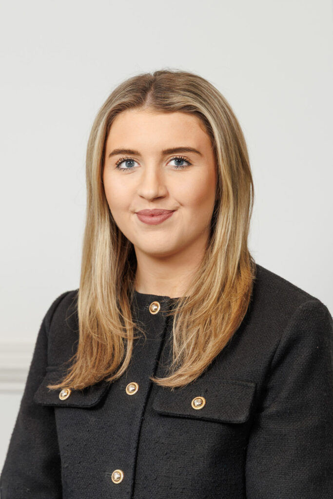Professional portrait of a smiling young woman.