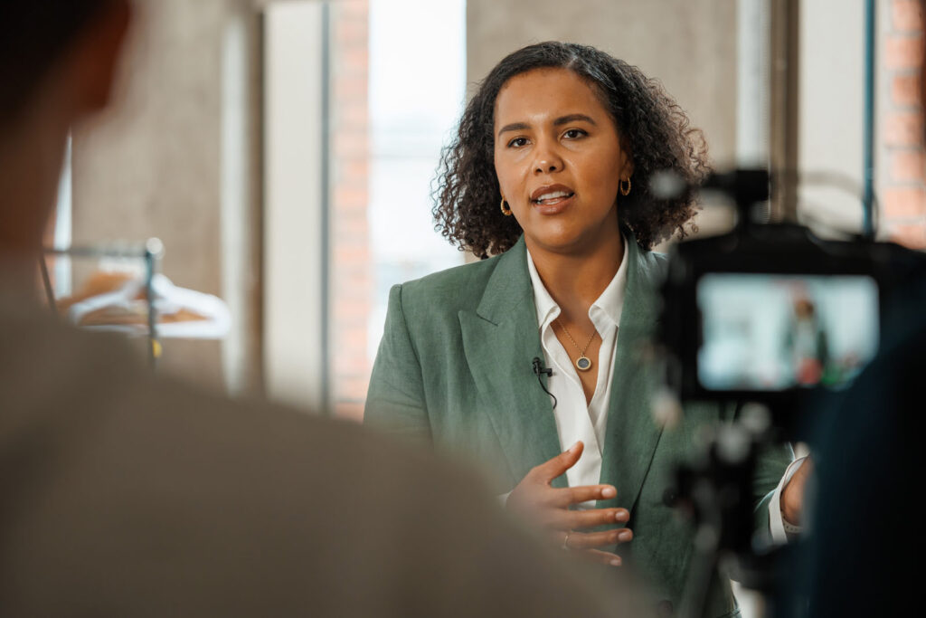 Professional woman speaks during video interview.