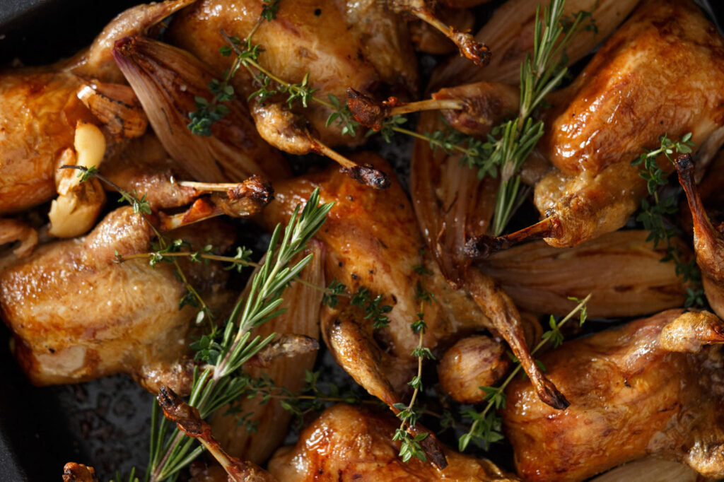 Roasted quails with herbs and garlic.