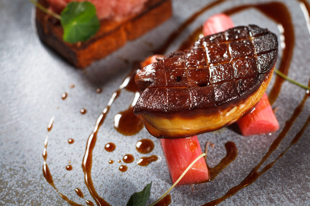 Seared foie gras with rhubarb and sauce, gourmet presentation.