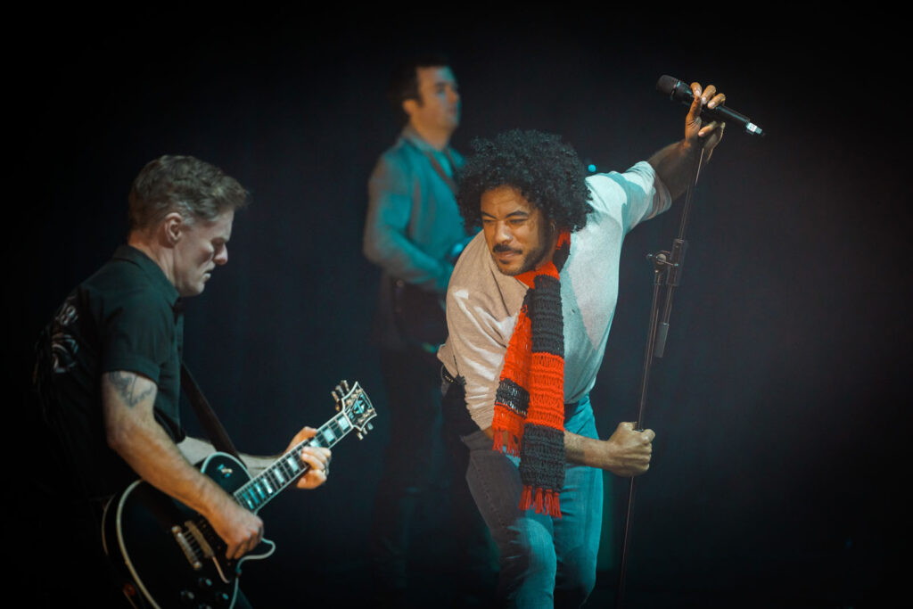 Singer and guitarist performing on stage.