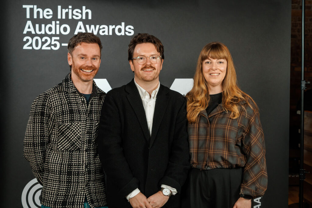 Smiling trio at Irish Audio Awards 2025 event.