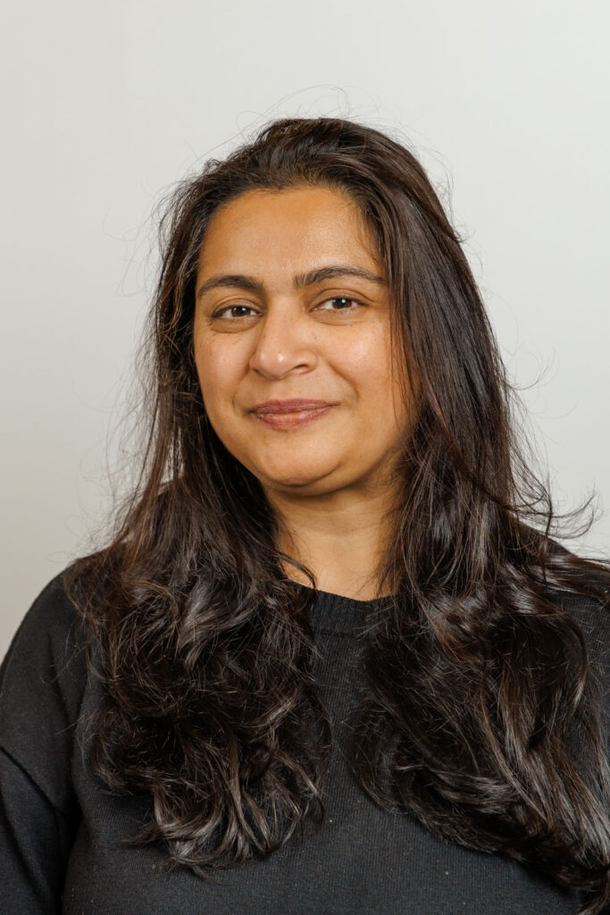 Smiling woman with long dark hair, headshot.