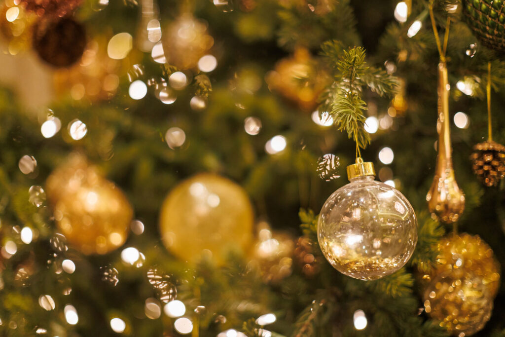 Sparkling golden ornaments on a festive Christmas tree.