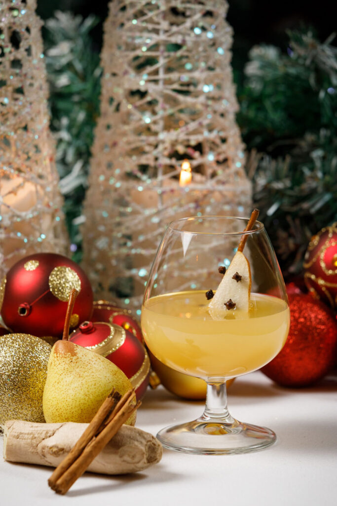 Spiced pear drink amidst festive Christmas decorations.