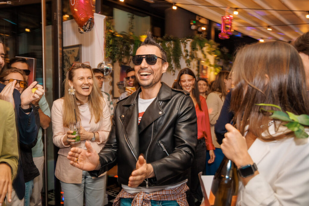 Stylish man laughing and enjoying a party with friends.